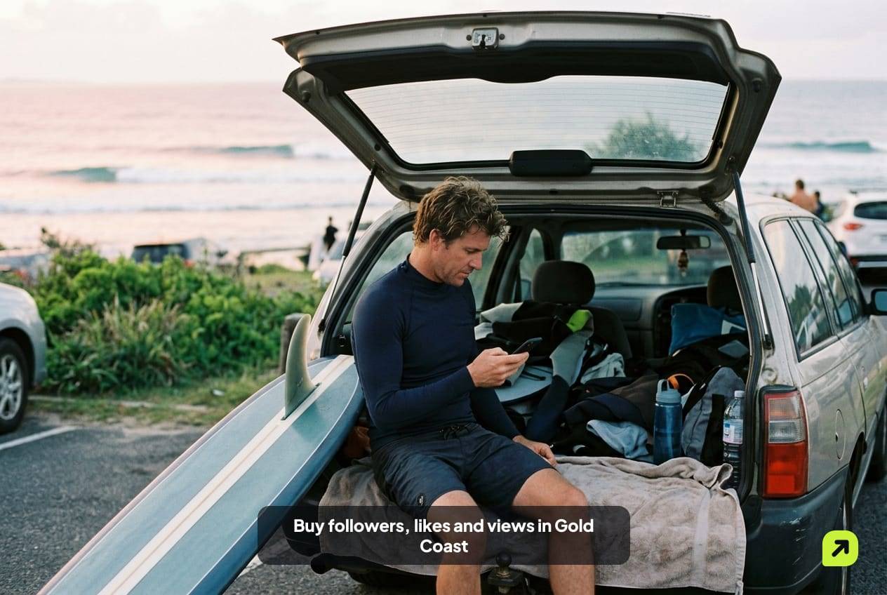 Surfer in a rash vest on a station wagon tailgate in a Coolangatta car park at dawn, checking his phone