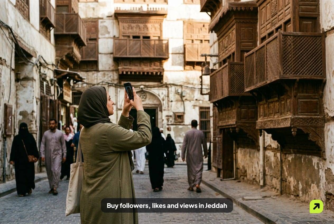 Creator photographing carved wooden balconies in the Al-Balad historic district of Jeddah in morning light