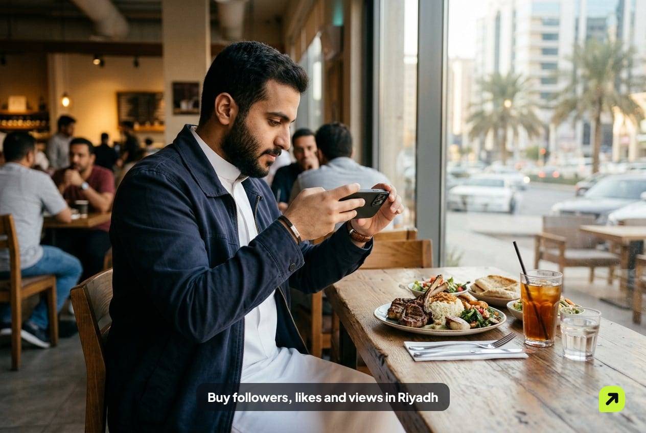 Creator filming a plated dish at a café window in Olaya, Riyadh, in soft late-afternoon light