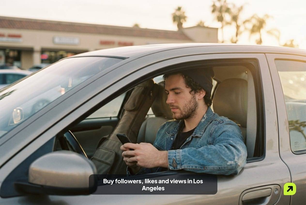 Musician in a parked car outside a Valley recording studio at golden hour, guitar case beside him, looking at his phone
