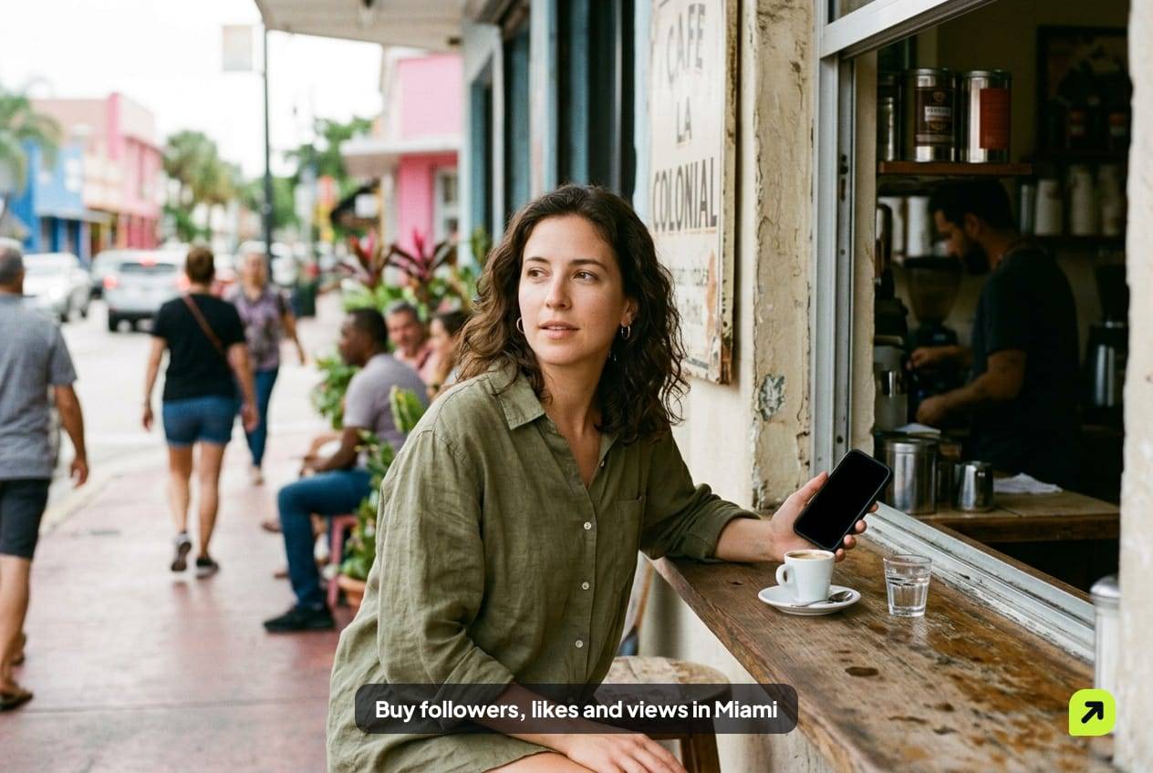 Woman at a Little Havana coffee window in morning light, holding her phone, a small cup of coffee beside her